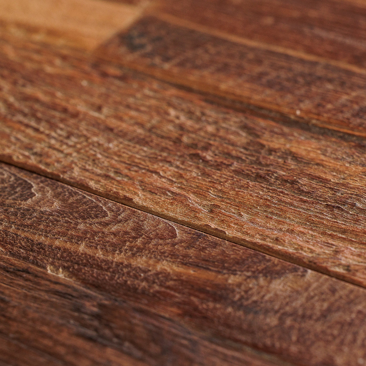 Close-up of dark textured floorboards and a narrow joint