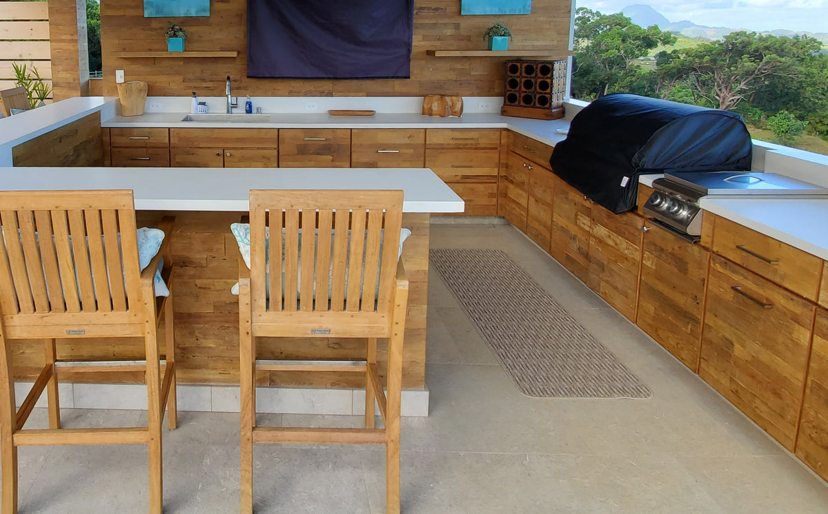 Outdoor kitchen with wood cabinet fronts and pale counters