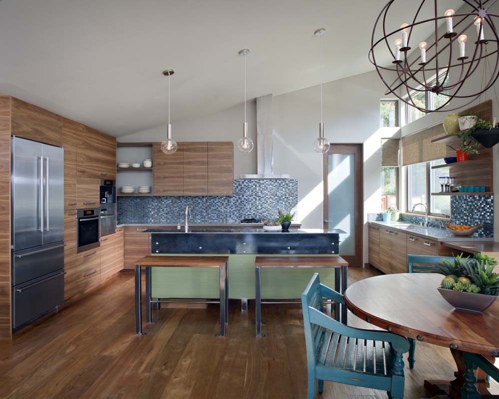 Kitchen with wood flooring, wood cabinet fronts, stone counters, and metal pendant