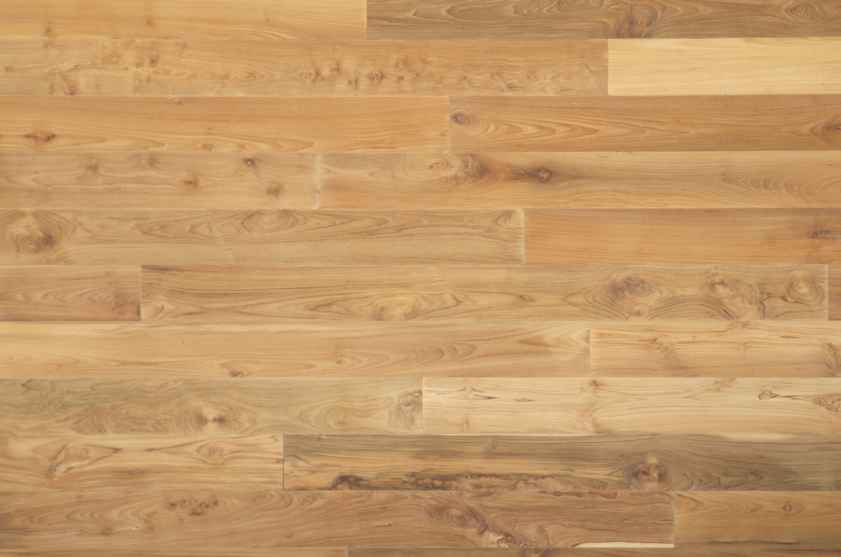 Close overhead view of pale wood planks with visible knots and tonal variation