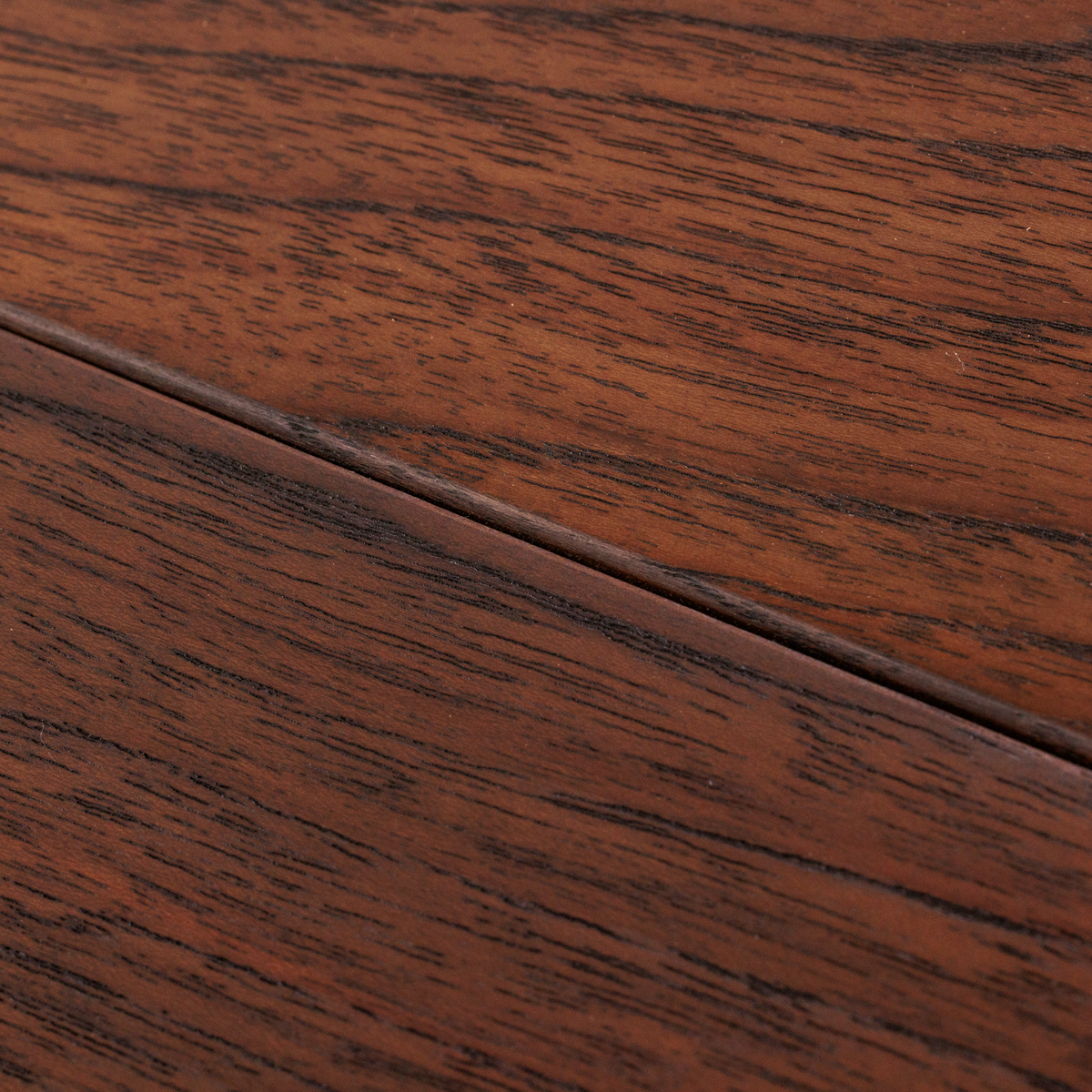 Close view of dark brown teak decking grain and a board joint