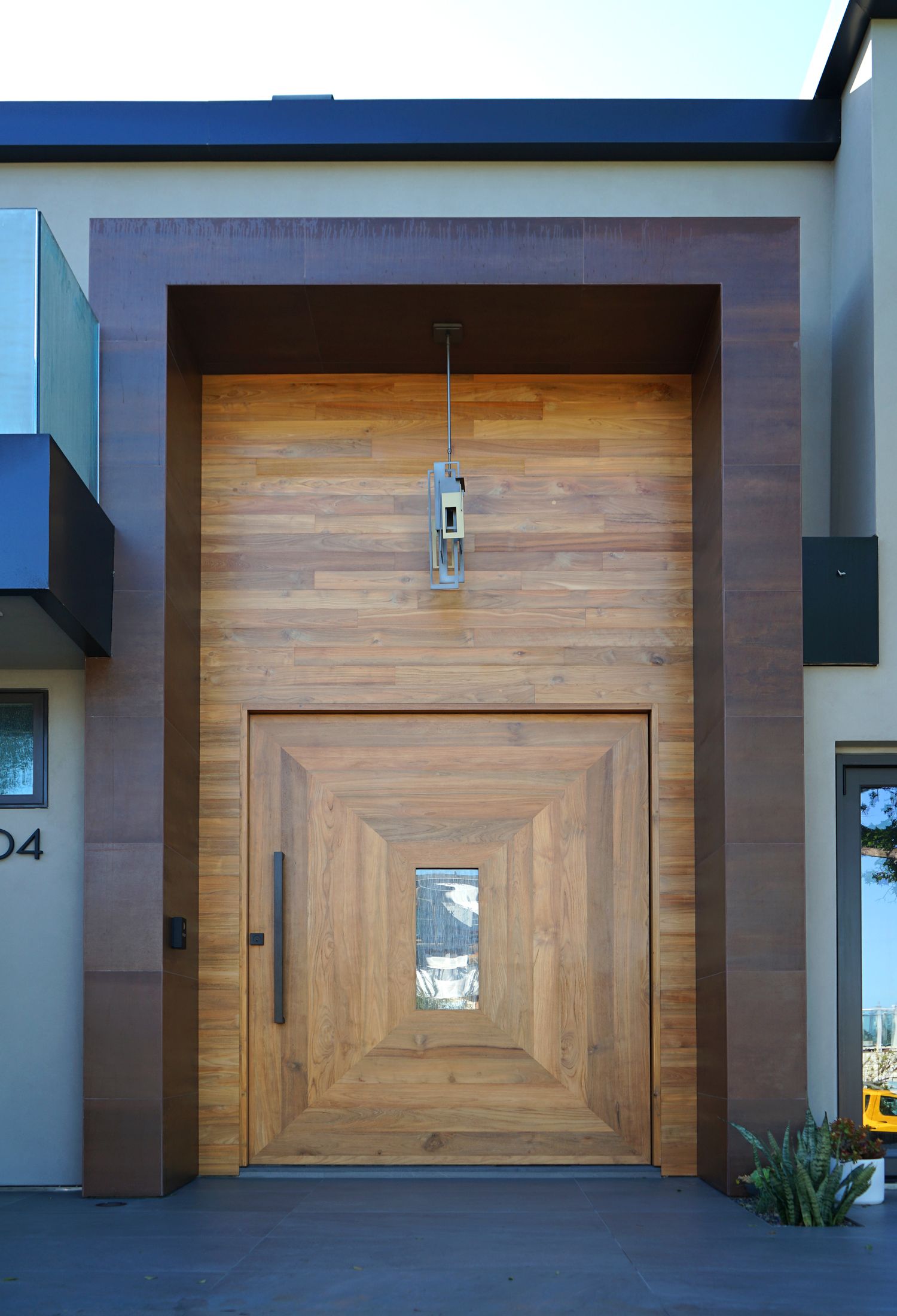 A geometric pivot front door built by IndoTeak